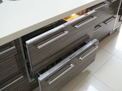 A close up of the built under fridge and freezer drawers