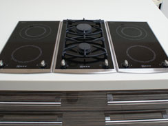 A close up of the twin gas hob sandwiched by two twin induction hobs