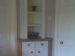 A bespoke corner unit to match the painted oak shaker style kitchen